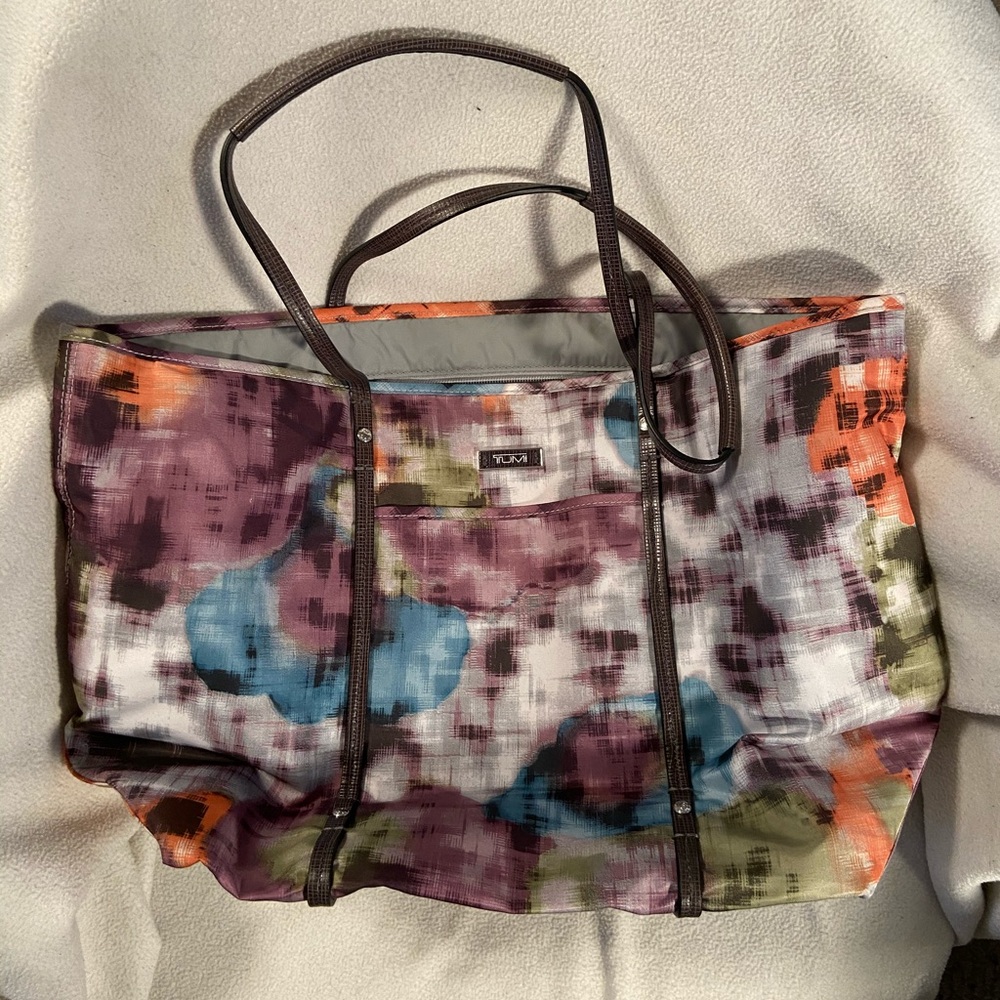 multicolored tumi shoulder bag